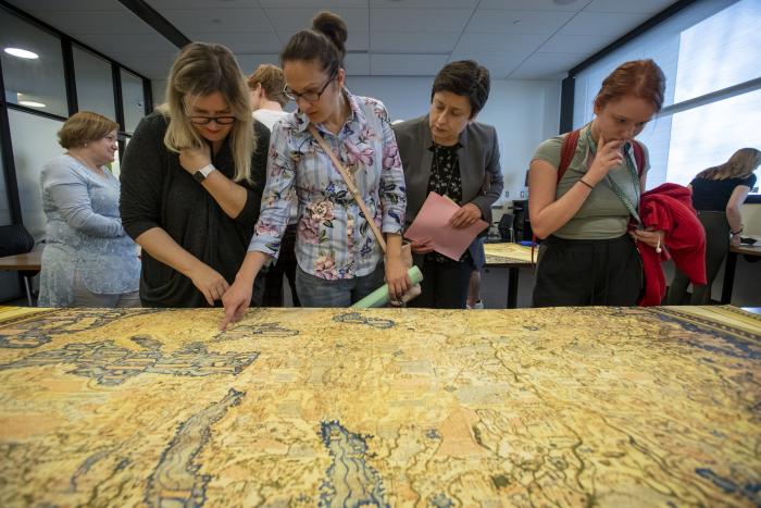 visitors looking over the maps